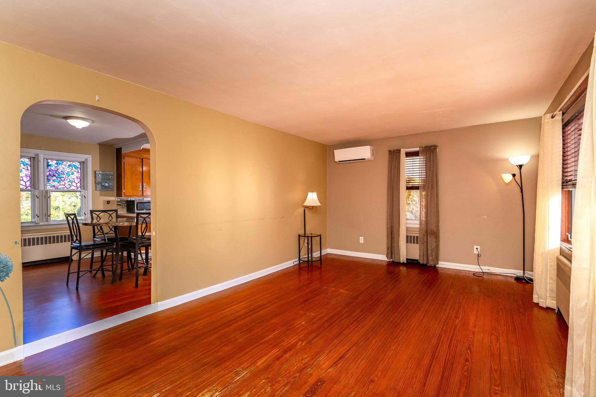 340 High Street Woodbury, NJ 08096 - Photo 5 of 14 a view of an empty room with wooden floor and a window