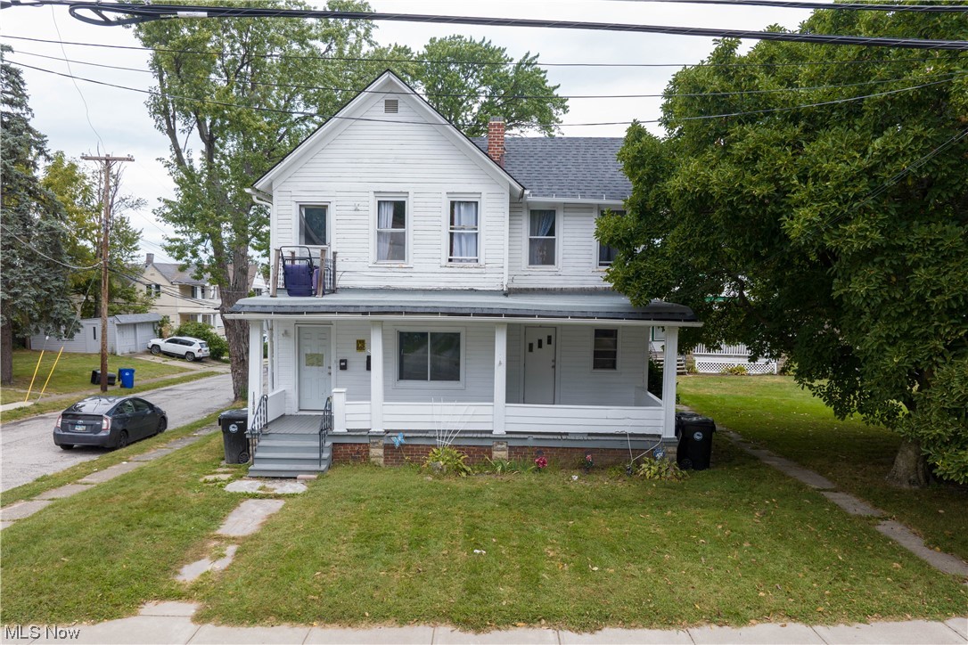 11838 Triskett Road Cleveland, OH 44111 - Photo 19 of 20 Farmhouse featuring a front lawn and covered porch