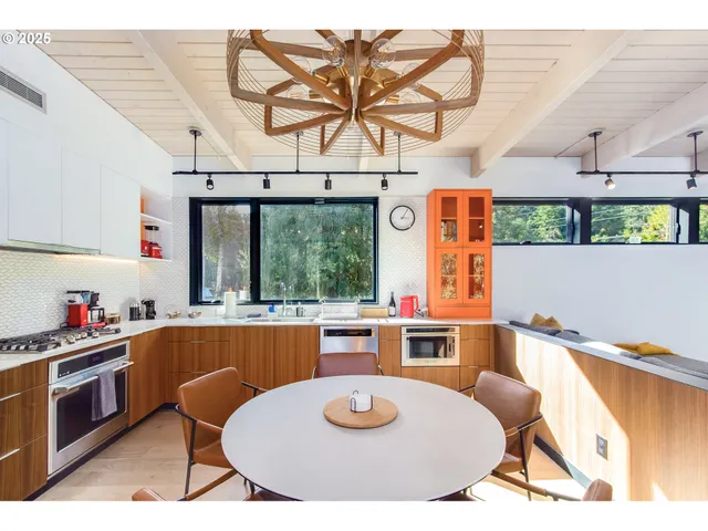 a kitchen with stainless steel appliances kitchen island granite countertop a sink and cabinets