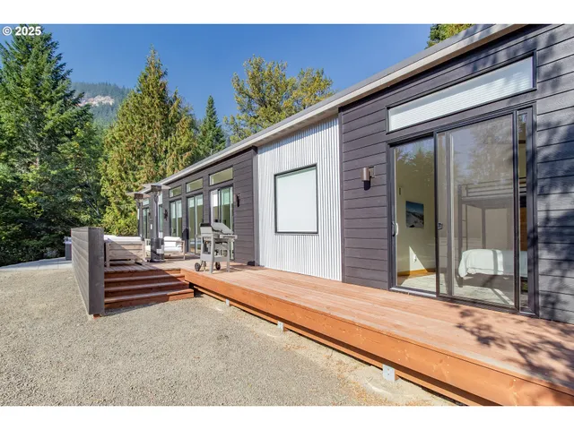 a backyard of a house with basket ball court and outdoor seating