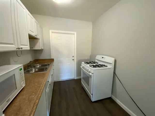 a kitchen with a stove and a microwave