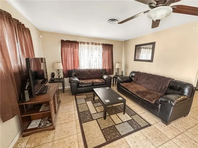 a living room with furniture fireplace and a window