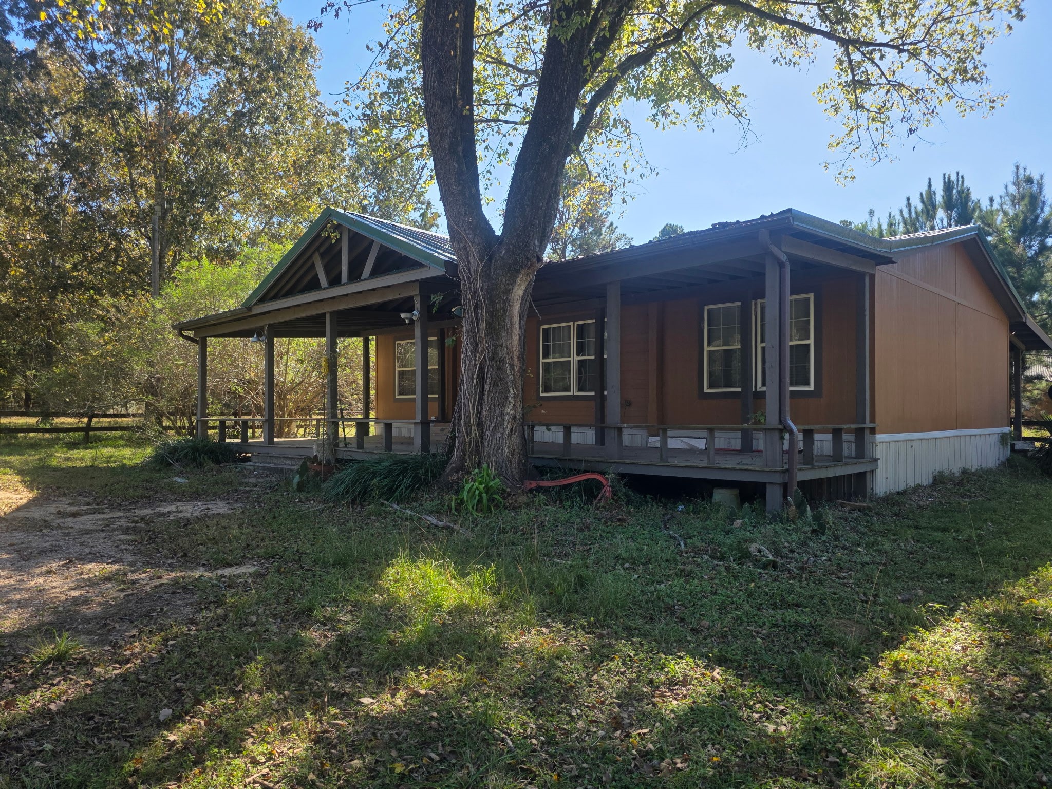 633 Ira Denson Road Coldspring, TX 77331 - Photo 2 of 27 a view of a house with backyard and garden