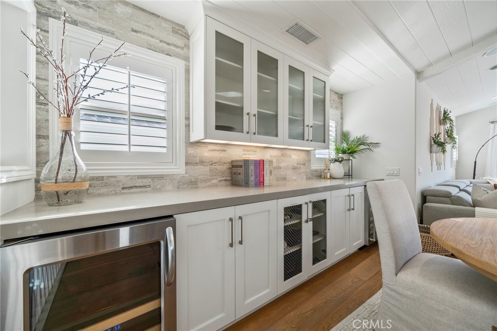 33 Cassis Dana Point, CA 92629 - Photo 12 of 49 a kitchen with granite countertop a sink and a white wooden cabinets