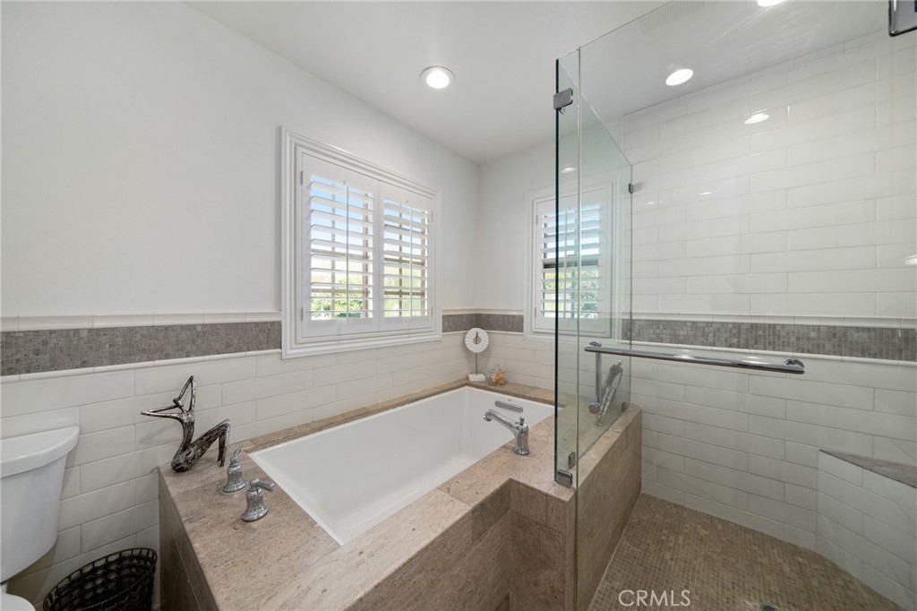 33 Cassis Dana Point, CA 92629 - Photo 21 of 49 a bathroom with a bathtub a toilet and a shower