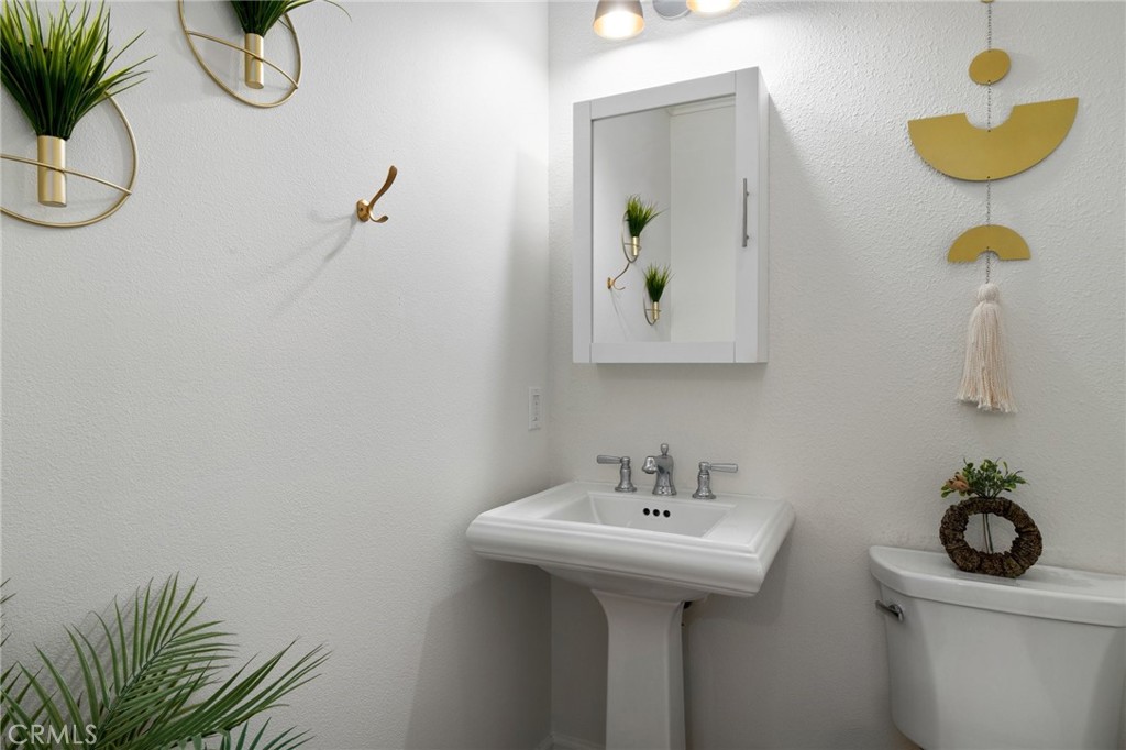 33 Cassis Dana Point, CA 92629 - Photo 28 of 49 a bathroom with a sink a mirror and vanity