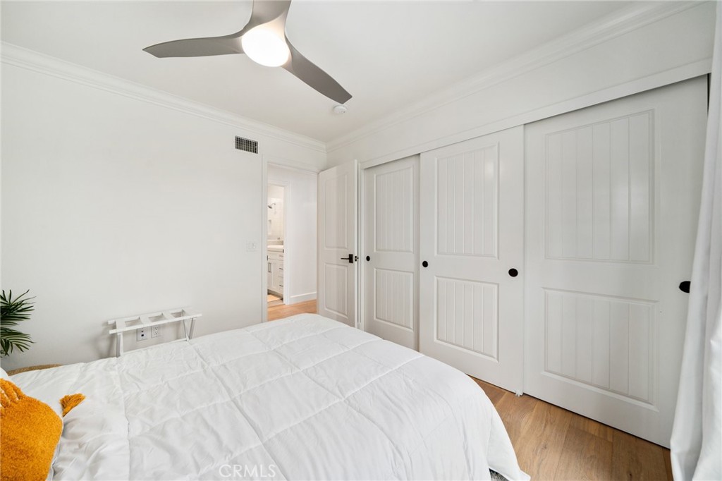 33 Cassis Dana Point, CA 92629 - Photo 32 of 49 a large bedroom with a bed and a chandelier