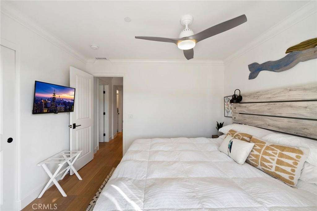 33 Cassis Dana Point, CA 92629 - Photo 37 of 49 a bedroom with a bed and a chandelier