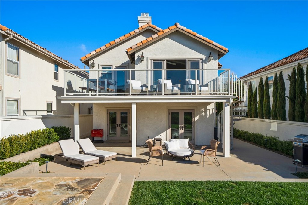 33 Cassis Dana Point, CA 92629 - Photo 44 of 49 a view of a patio with table and chairs potted plants and palm tree