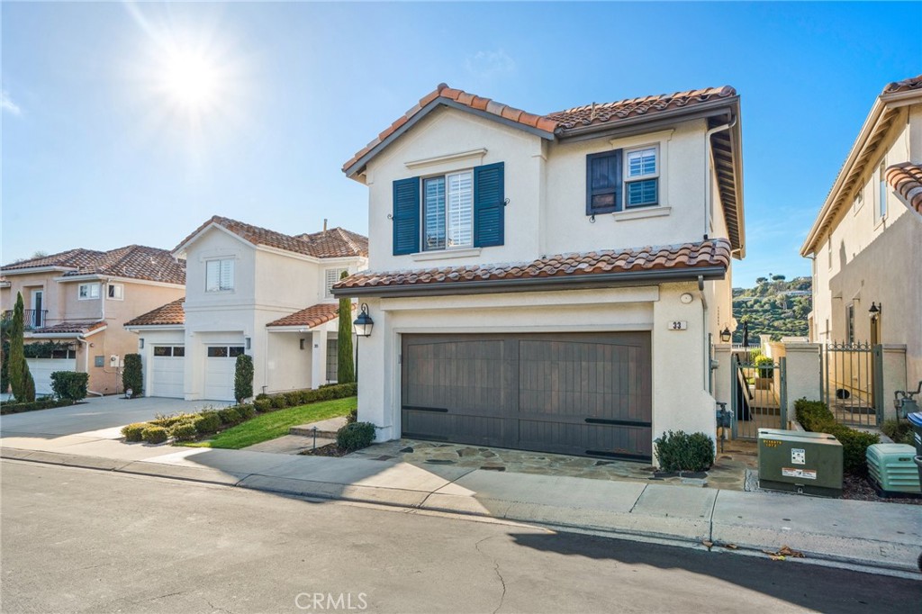 33 Cassis Dana Point, CA 92629 - Photo 48 of 49 a front view of a house with a yard and garage