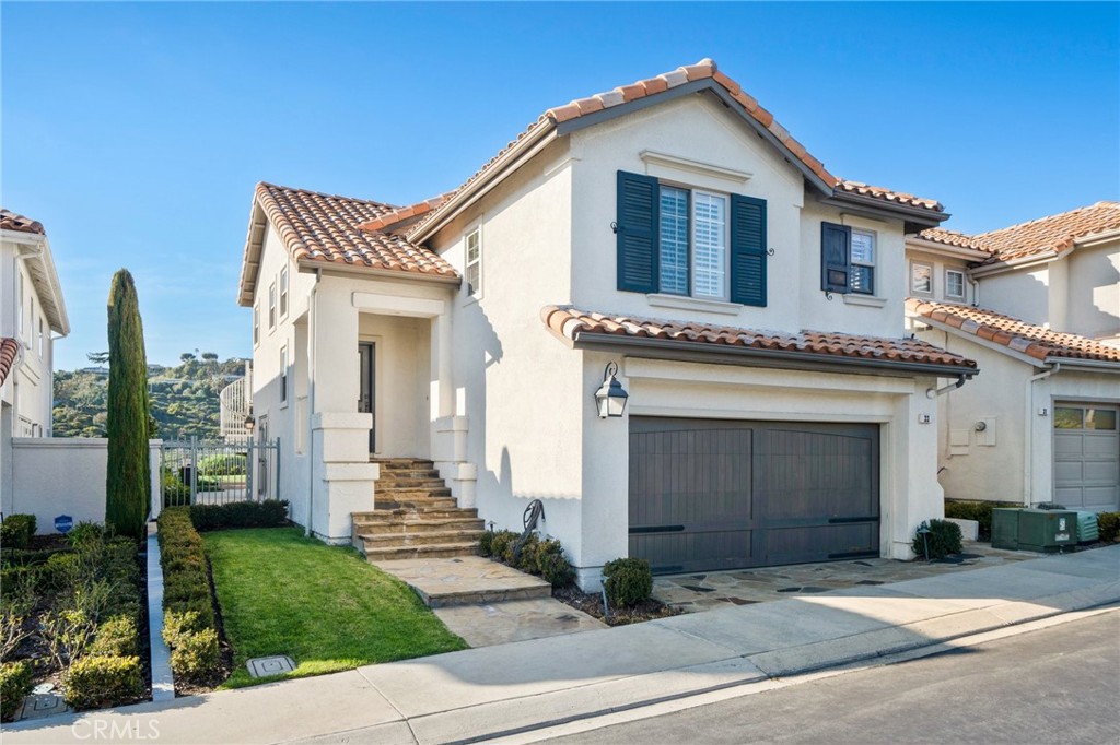 33 Cassis Dana Point, CA 92629 - Photo 49 of 49 a front view of a house with a yard and garage
