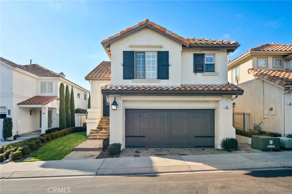 33 Cassis Dana Point, CA 92629 - Photo 5 of 49 a front view of a house with a yard and garage