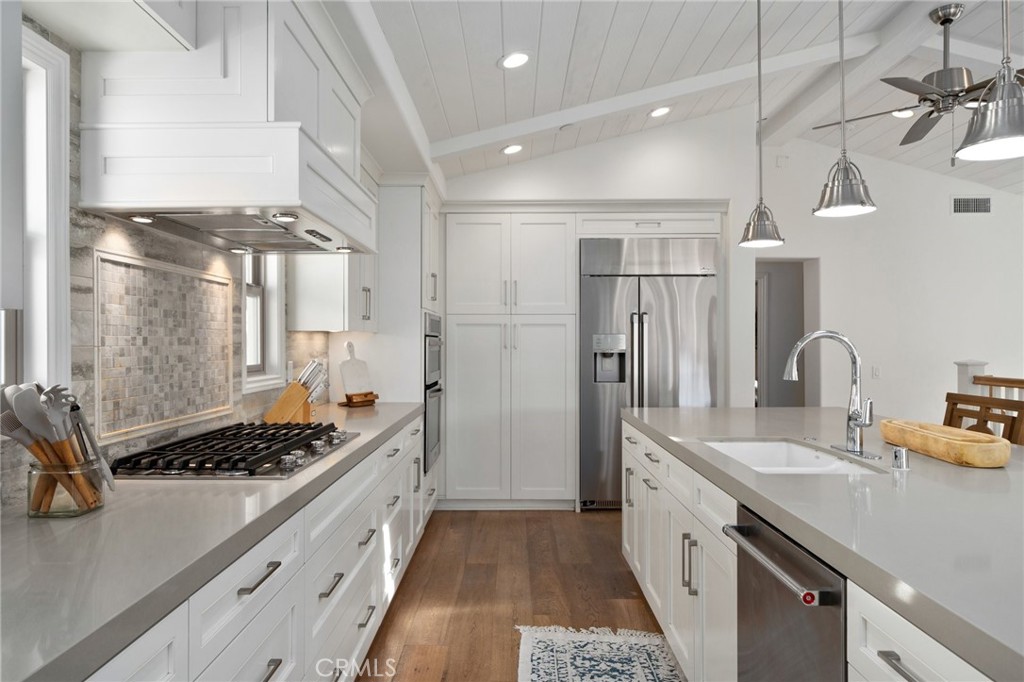 33 Cassis Dana Point, CA 92629 - Photo 7 of 49 a kitchen with stainless steel appliances a sink stove and refrigerator
