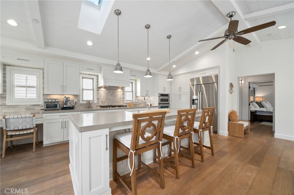 33 Cassis Dana Point, CA 92629 - Photo 9 of 49 a kitchen with stainless steel appliances a table chairs refrigerator and sink