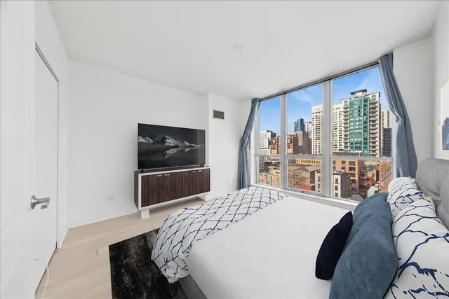 a bedroom with a bed and a television