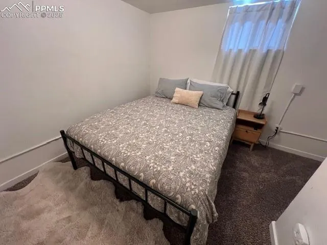 a bedroom with a bed and a mirror