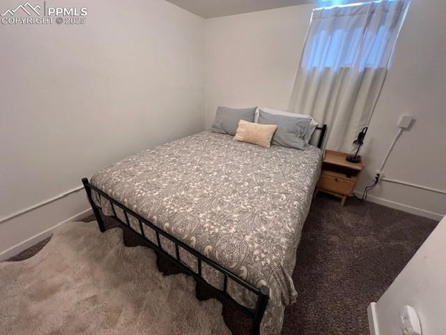 1819 East Yampa Street Colorado Springs, CO 80909 - Photo 21 of 25 a bed sitting in a bedroom next to a window