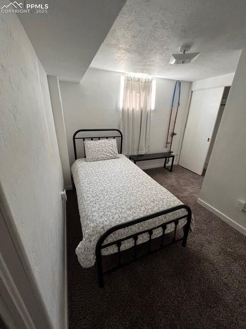 1819 East Yampa Street Colorado Springs, CO 80909 - Photo 22 of 25 a bedroom with a bed and a mirror