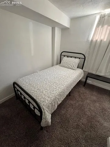 a bedroom with furniture and a rug