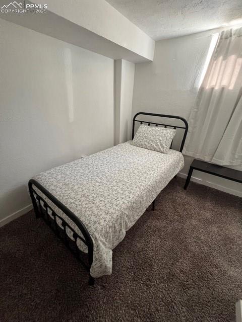 1819 East Yampa Street Colorado Springs, CO 80909 - Photo 23 of 25 a bed sitting in a bedroom next to a window