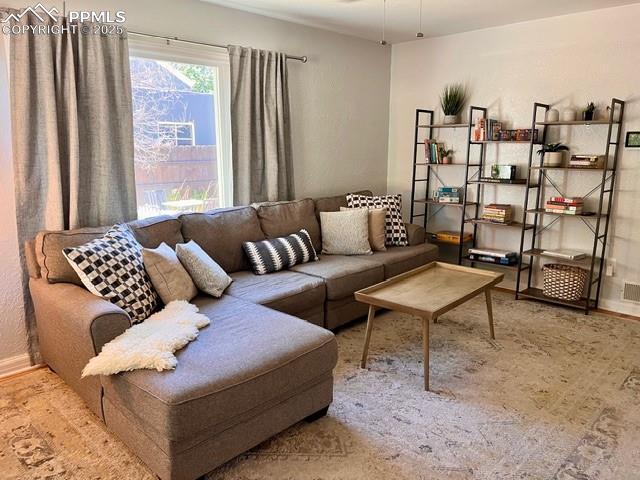 1819 East Yampa Street Colorado Springs, CO 80909 - Photo 3 of 25 a living room with furniture and a large window