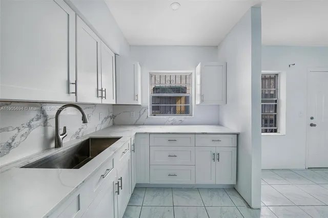 a kitchen with a sink and cabinets