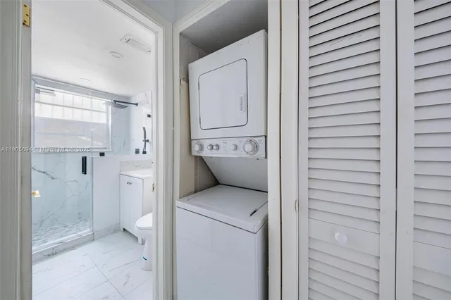 a bathroom with a granite countertop shower mirror and toilet