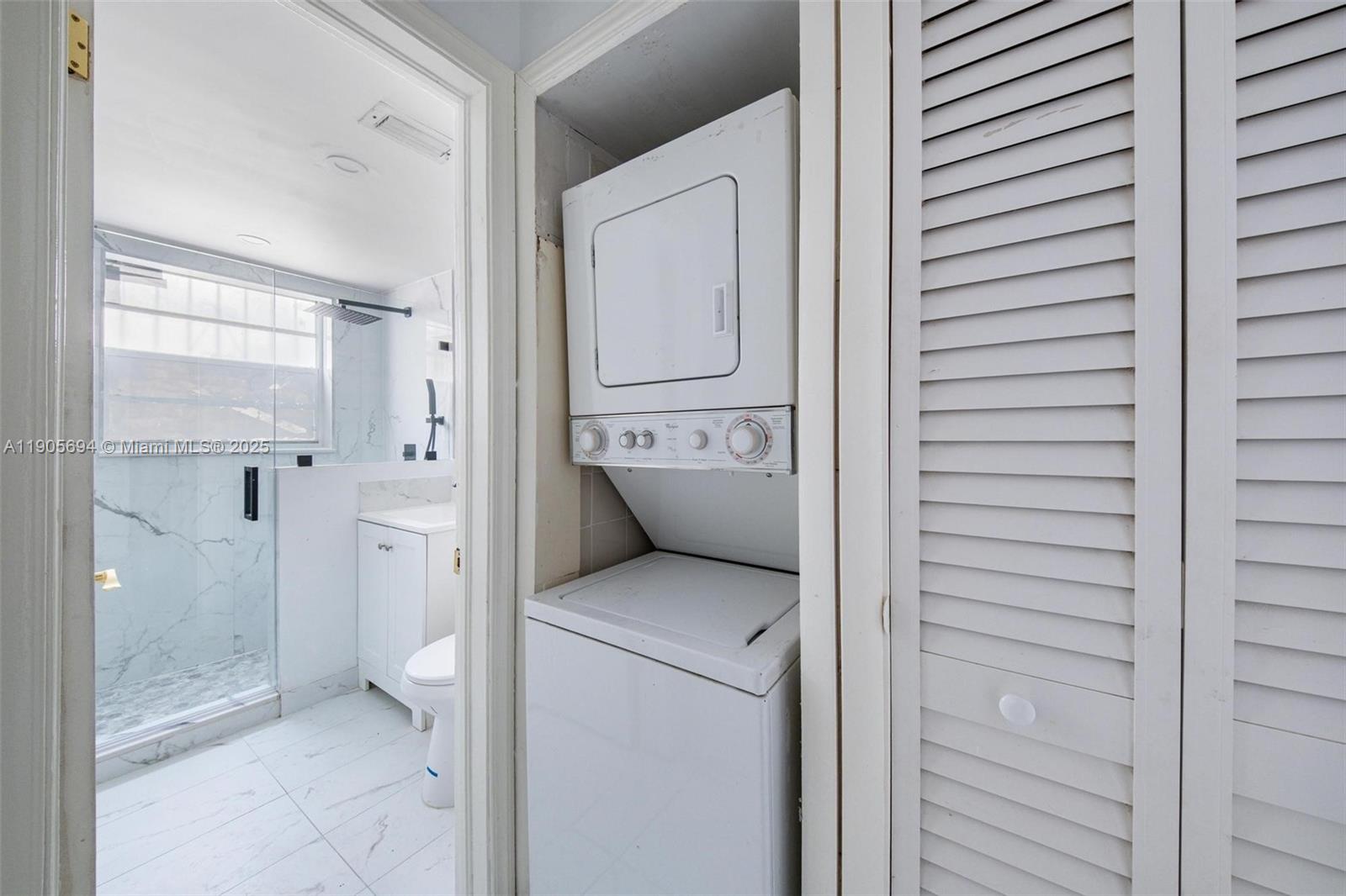 7712 Byron Avenue, Unit 2 Miami Beach, FL 33141 - Photo 14 of 24 a bathroom with a granite countertop shower mirror and toilet