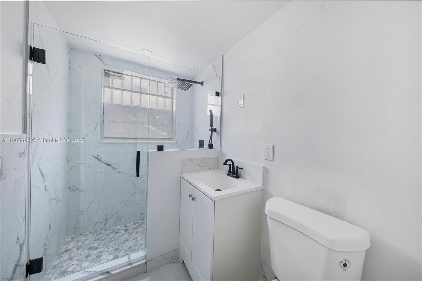 7712 Byron Avenue, Unit 2 Miami Beach, FL 33141 - Photo 15 of 24 a bathroom with a sink a toilet and shower