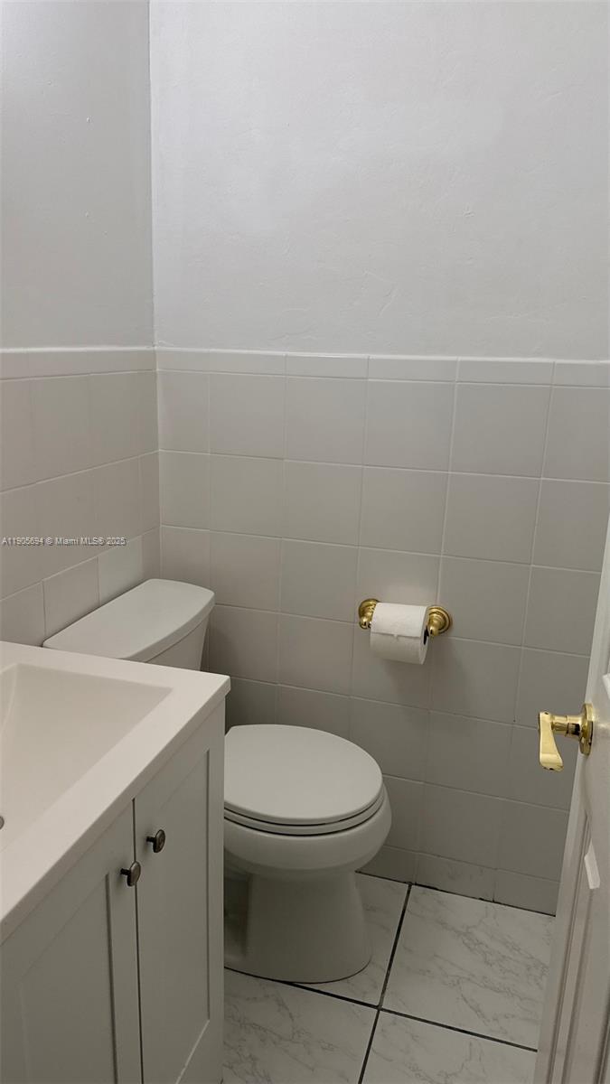 7712 Byron Avenue, Unit 2 Miami Beach, FL 33141 - Photo 20 of 24 a bathroom with a toilet and a sink