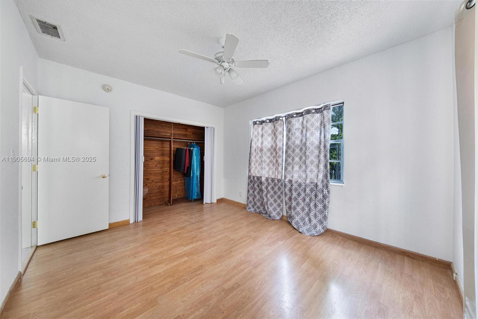 7712 Byron Avenue, Unit 2 Miami Beach, FL 33141 - Photo 22 of 24 a view of empty room with wooden floor