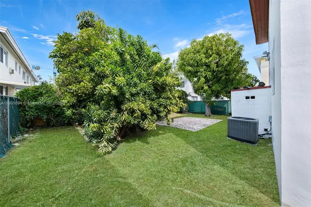 a view of a backyard with a garden and plants