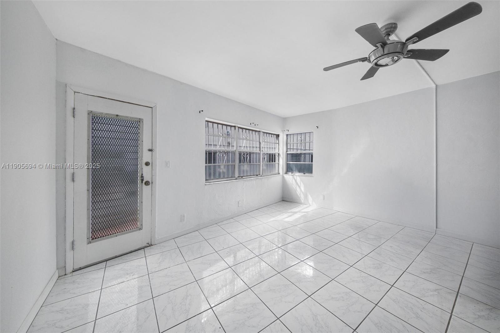 7712 Byron Avenue, Unit 2 Miami Beach, FL 33141 - Photo 5 of 24 a view of an empty room with a window