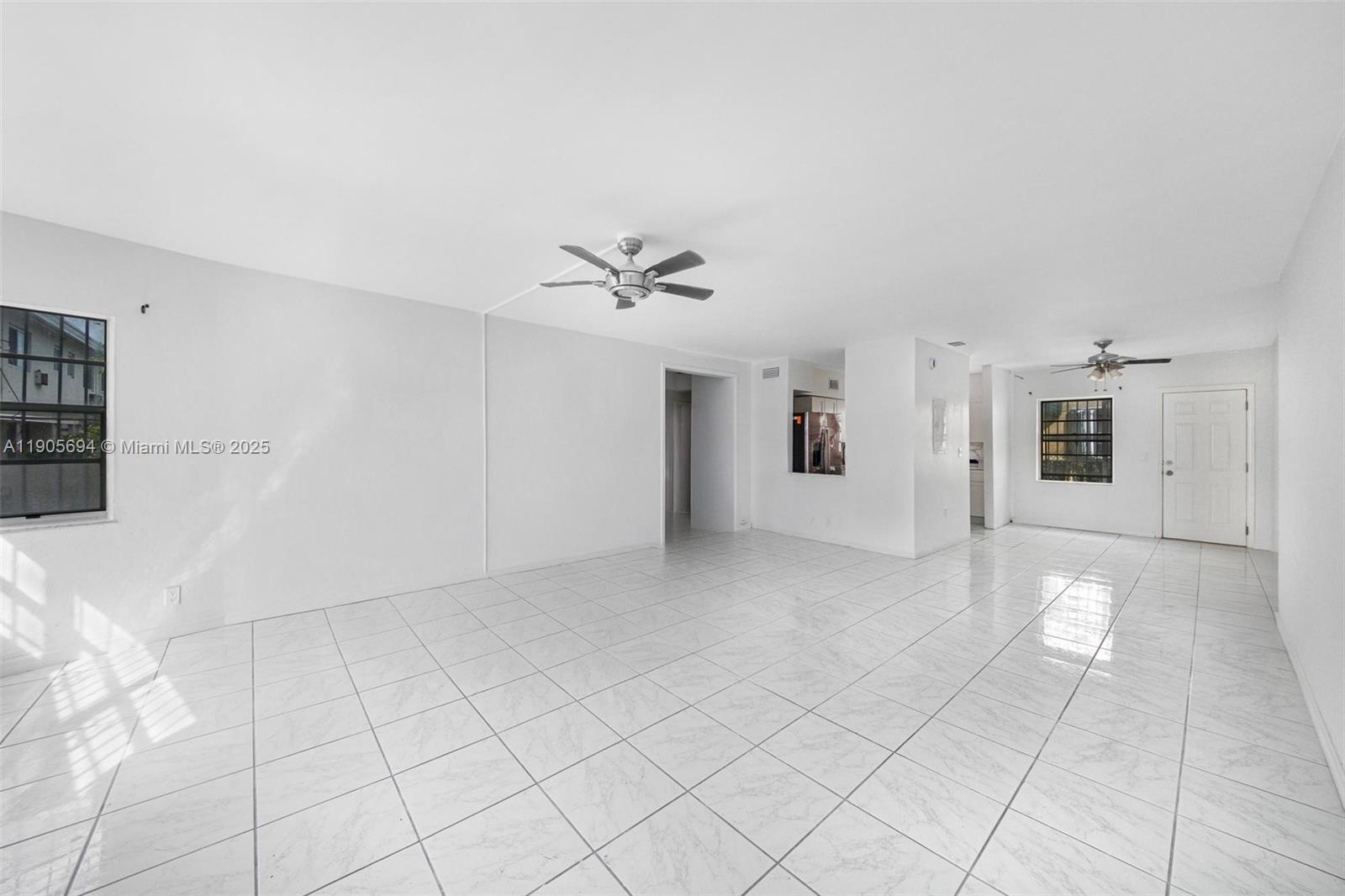 7712 Byron Avenue, Unit 2 Miami Beach, FL 33141 - Photo 6 of 24 a view of a livingroom with white walls