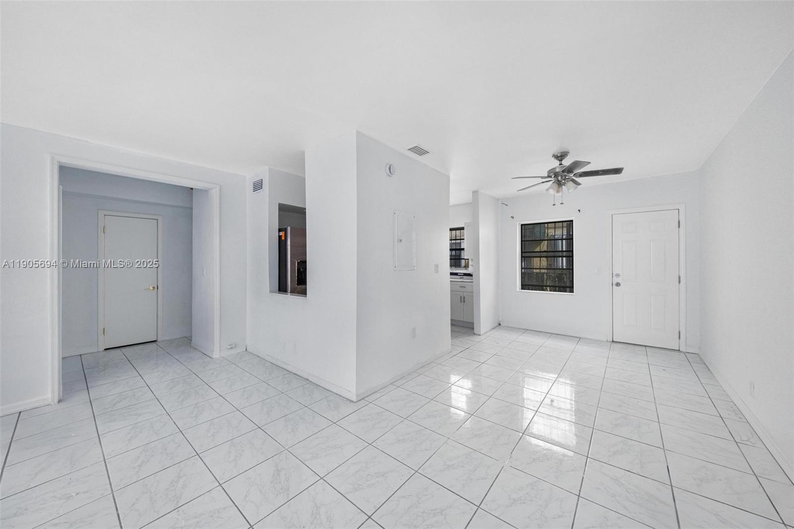 7712 Byron Avenue, Unit 2 Miami Beach, FL 33141 - Photo 8 of 24 an empty room with closet and windows