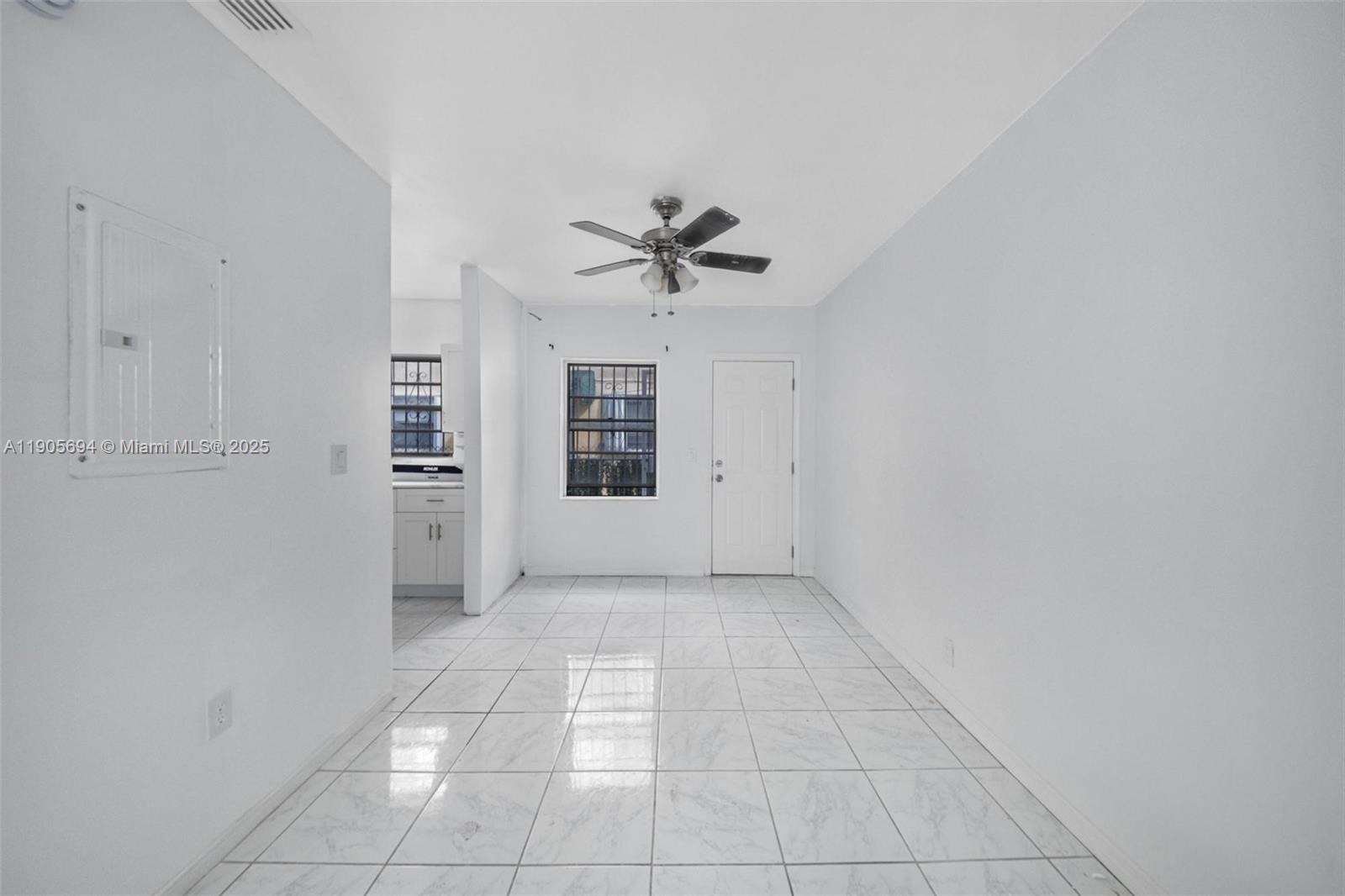 7712 Byron Avenue, Unit 2 Miami Beach, FL 33141 - Photo 9 of 24 an empty room with closet and a ceiling fan