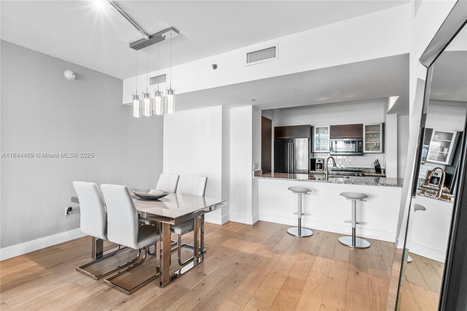 951 Brickell Avenue, Unit 1505 Miami, FL 33131 - Photo 15 of 48 a view of a dining room with furniture and wooden floor
