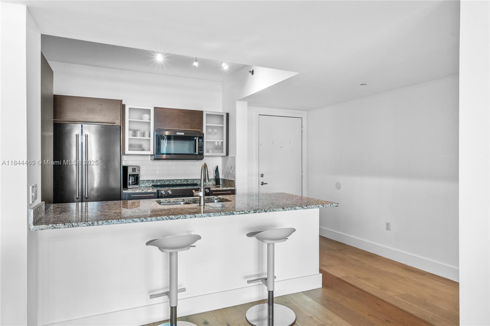 951 Brickell Avenue, Unit 1505 Miami, FL 33131 - Photo 16 of 48 a kitchen with kitchen island a counter top space cabinets and stainless steel appliances