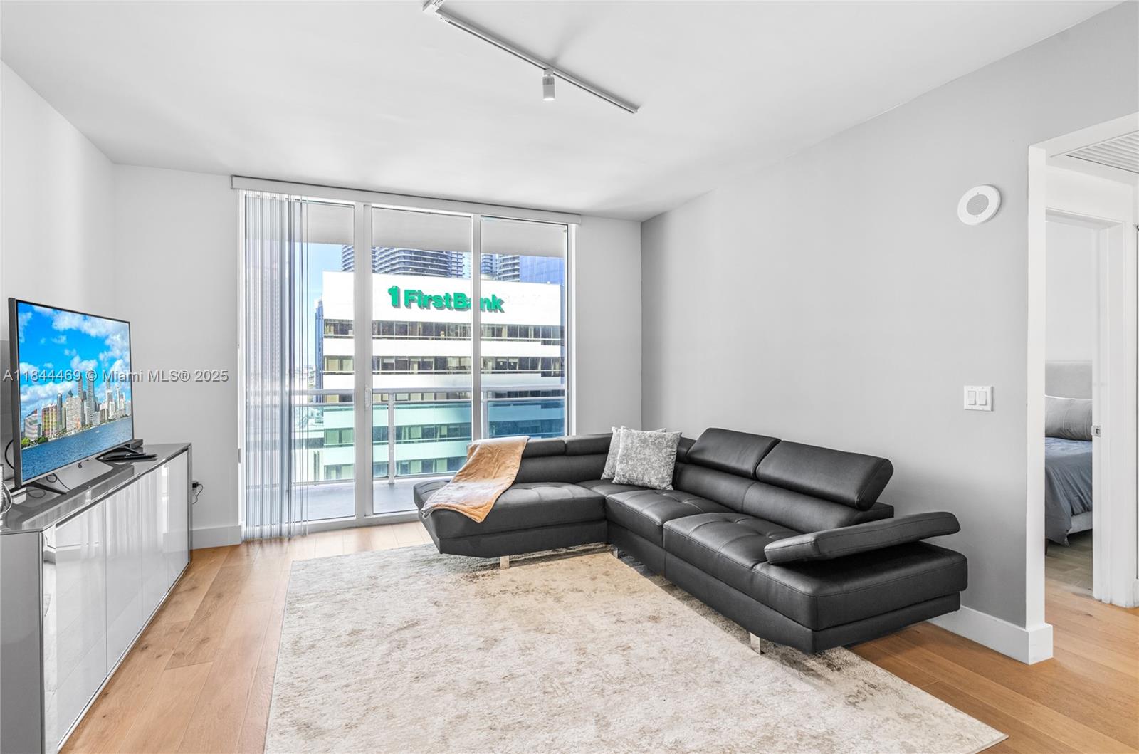 951 Brickell Avenue, Unit 1505 Miami, FL 33131 - Photo 17 of 48 a living room with furniture and a flat screen tv