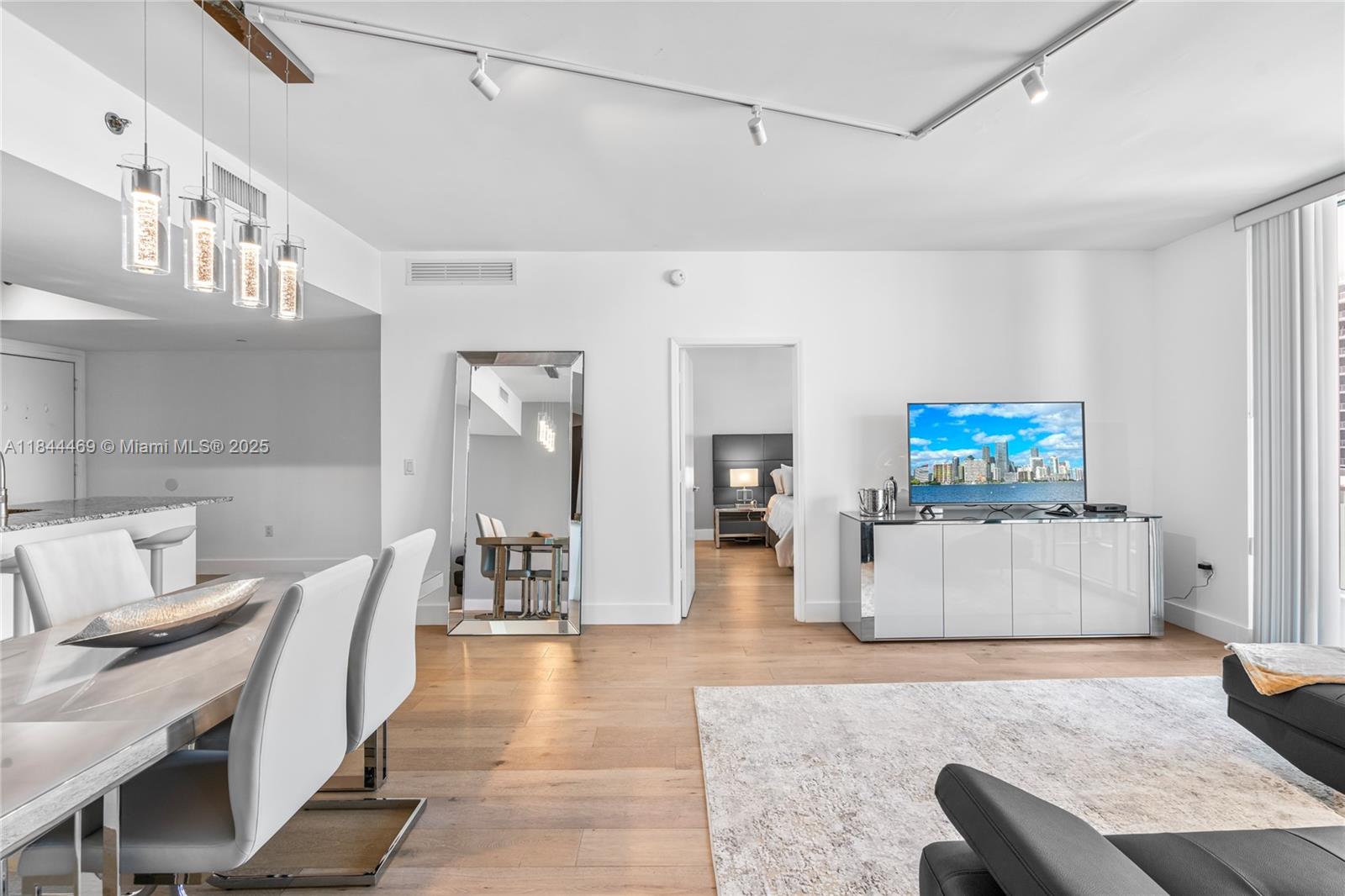 951 Brickell Avenue, Unit 1505 Miami, FL 33131 - Photo 19 of 48 a living room with furniture and a flat screen tv