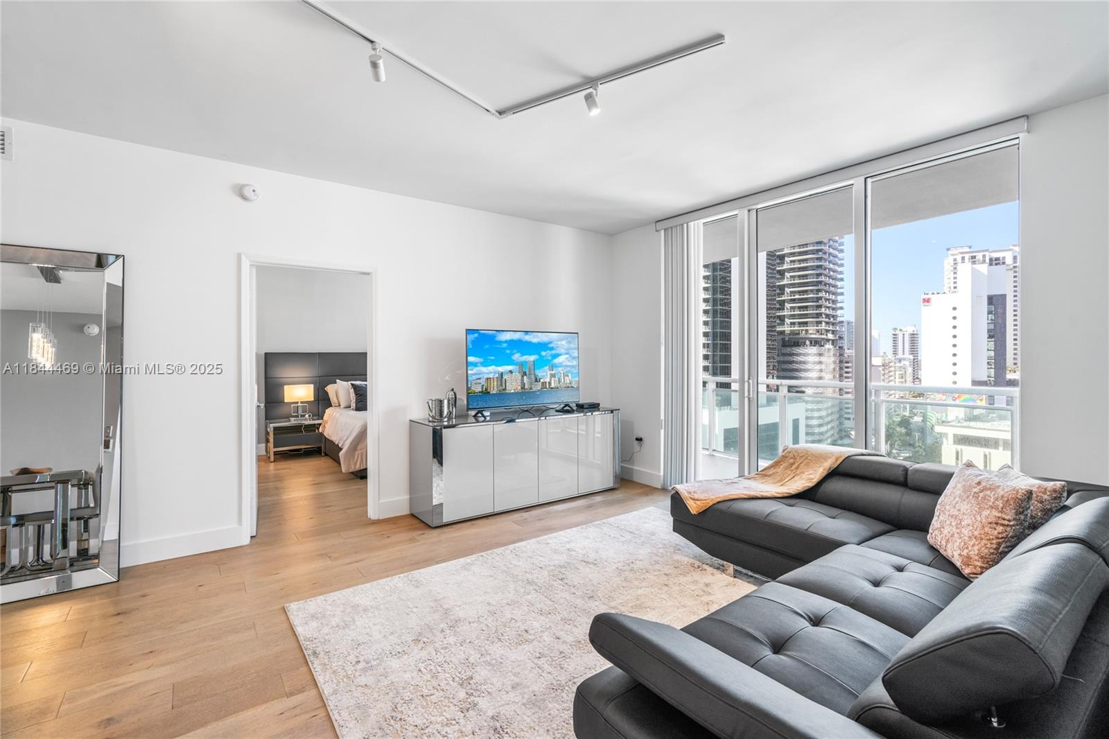951 Brickell Avenue, Unit 1505 Miami, FL 33131 - Photo 20 of 48 a living room with furniture and a large window