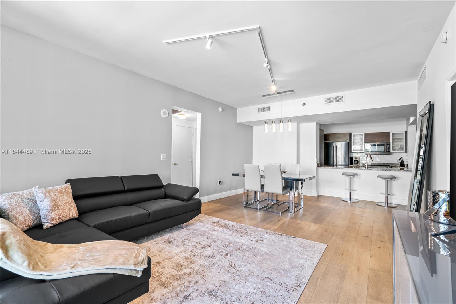 951 Brickell Avenue, Unit 1505 Miami, FL 33131 - Photo 21 of 48 a living room with furniture and a rug