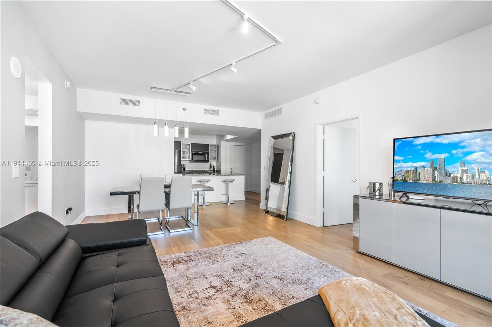 951 Brickell Avenue, Unit 1505 Miami, FL 33131 - Photo 22 of 48 a living room with furniture and a flat screen tv