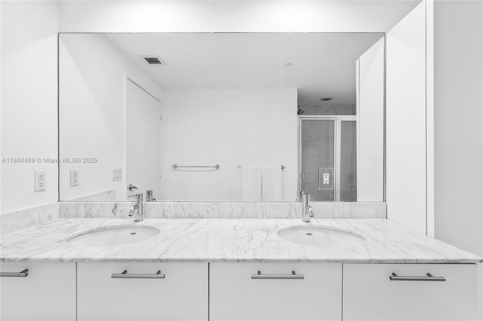 951 Brickell Avenue, Unit 1505 Miami, FL 33131 - Photo 28 of 48 a bathroom with a sink and a mirror