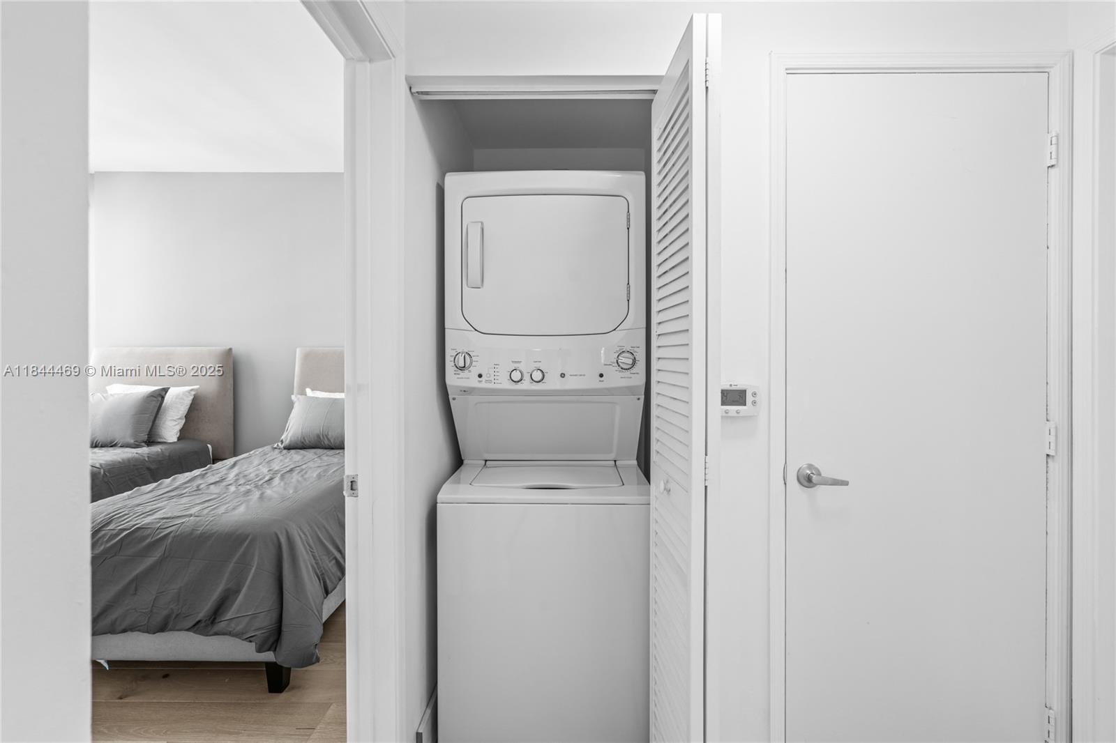 951 Brickell Avenue, Unit 1505 Miami, FL 33131 - Photo 31 of 48 a hallway with a couch and a washer dryer