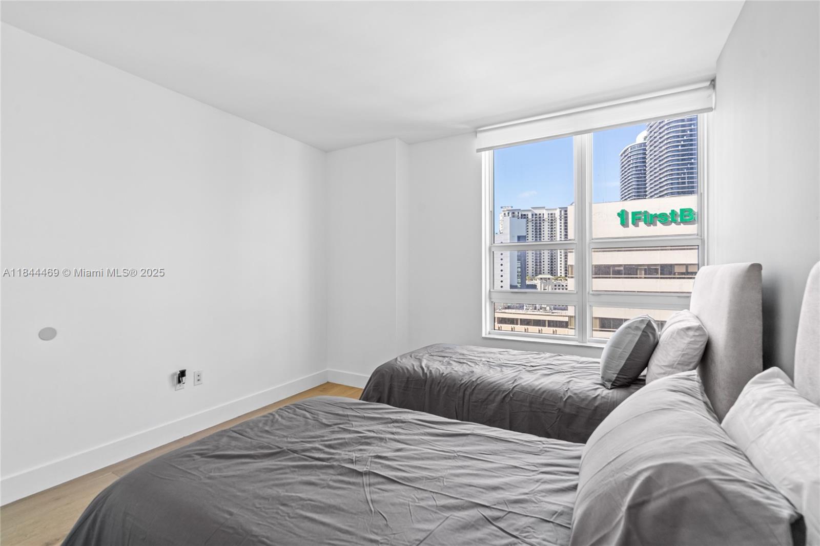 951 Brickell Avenue, Unit 1505 Miami, FL 33131 - Photo 33 of 48 a bedroom with a bed next to a window