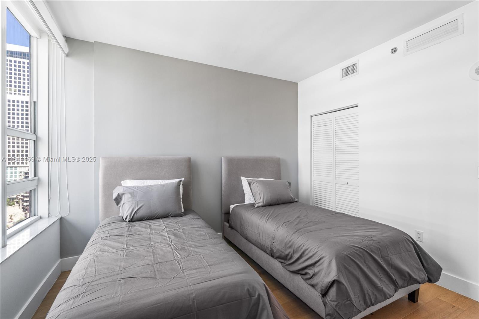 951 Brickell Avenue, Unit 1505 Miami, FL 33131 - Photo 34 of 48 a bedroom with a bed and wooden floor