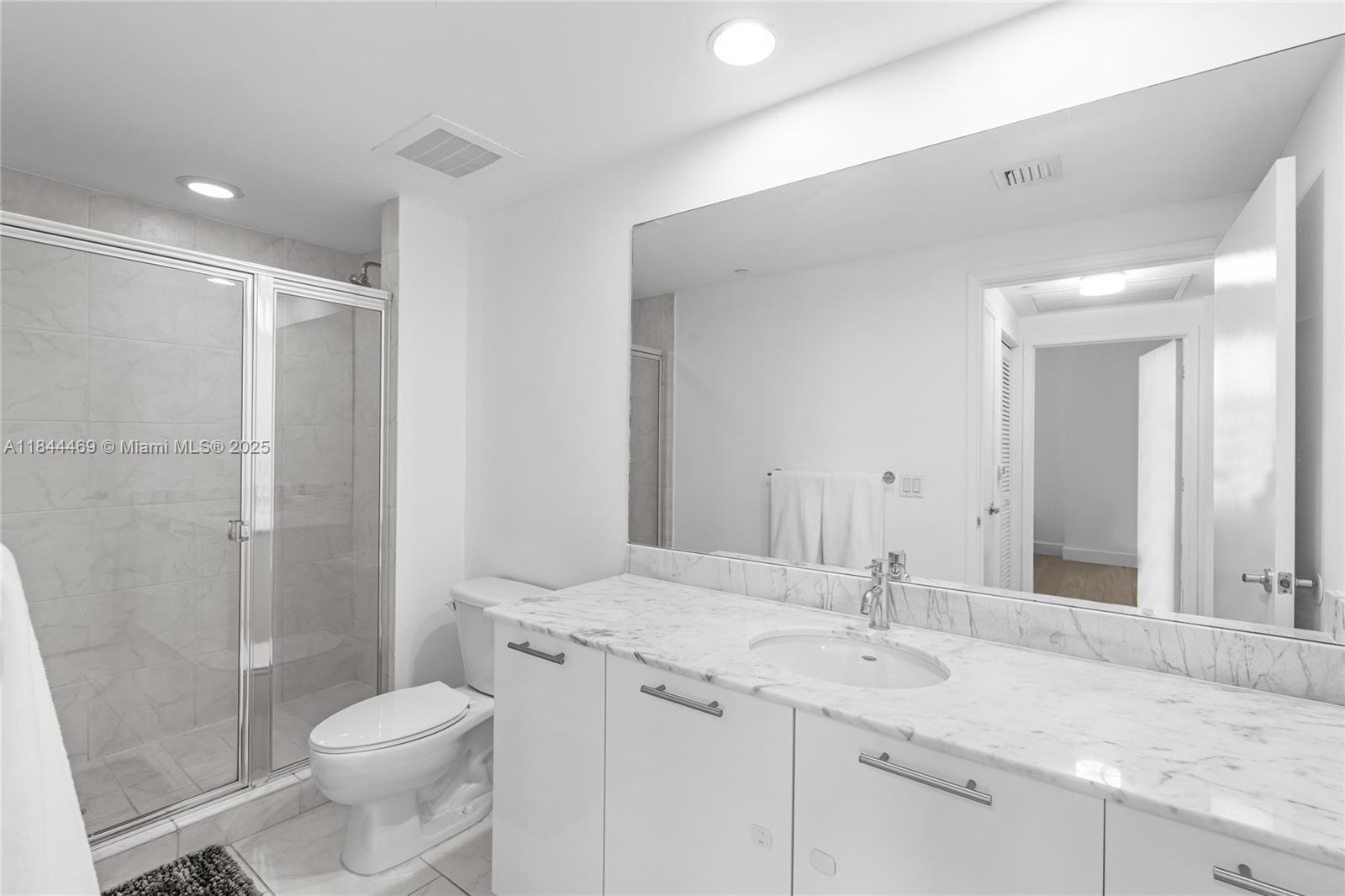 951 Brickell Avenue, Unit 1505 Miami, FL 33131 - Photo 35 of 48 a bathroom with a granite countertop sink toilet and shower