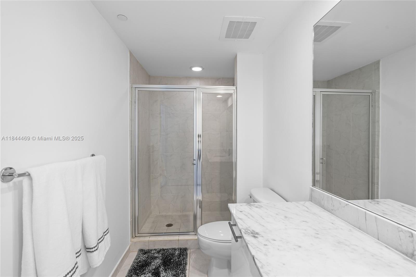 951 Brickell Avenue, Unit 1505 Miami, FL 33131 - Photo 36 of 48 a bathroom with a sink a toilet and shower