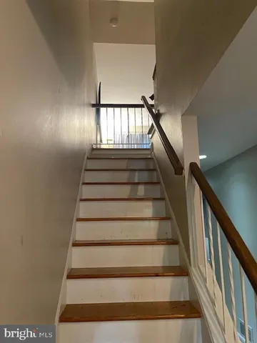 a view of a kitchen with stairs and an empty space